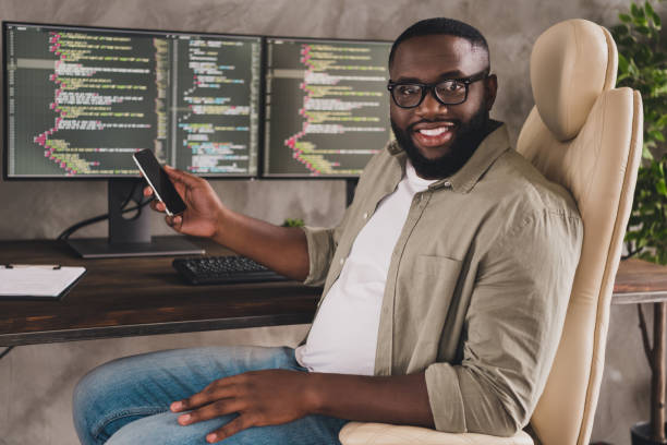 istock Portrait of handsome cheerful experienced guy geek freelancer using gadget at workplace workstation indoors 1397544629