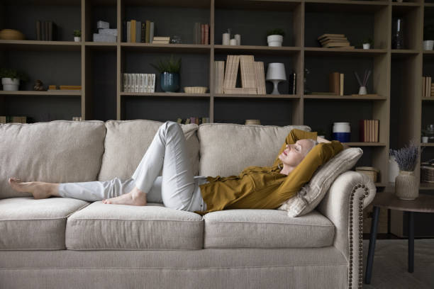 istock Peaceful calm mature woman lying on sofa with closed eyes 1397545791