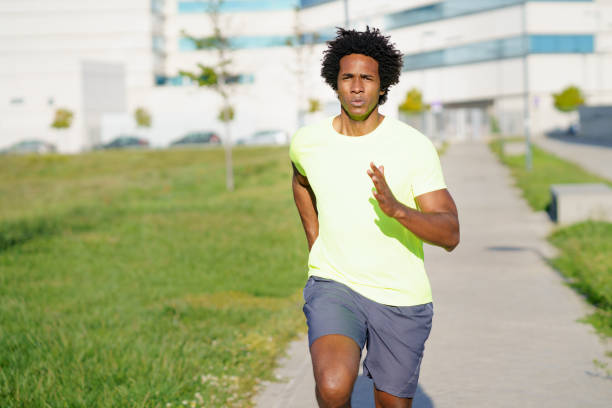 istock Black athletic man running in an urban park. 1397547397