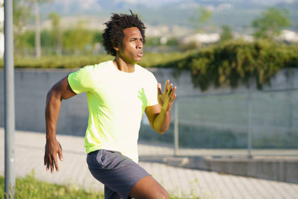 istock Black athletic man running in an urban park. 1397547474