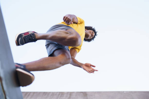 istock View from below of black man jumping on his run. 1397547529
