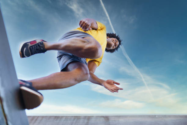 istock View from below of black man jumping on his run. 1397547531