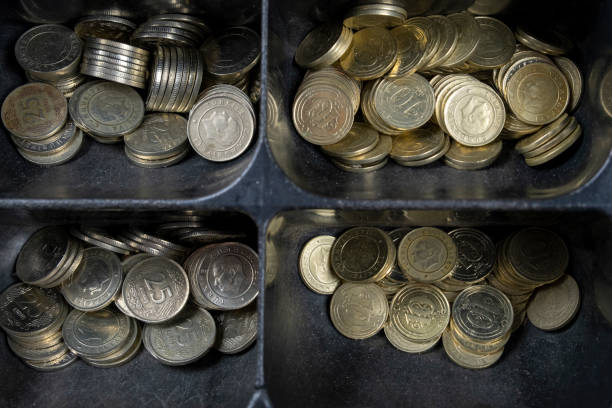 Several Turkish changes on black cash register, dusty coins, close-up, top view