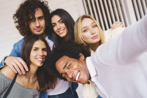 istock Multi-ethnic group of friends taking a selfie together while having fun outdoors. 1397548128