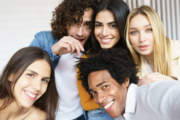 istock Multi-ethnic group of friends taking a selfie together while having fun outdoors. 1397548130