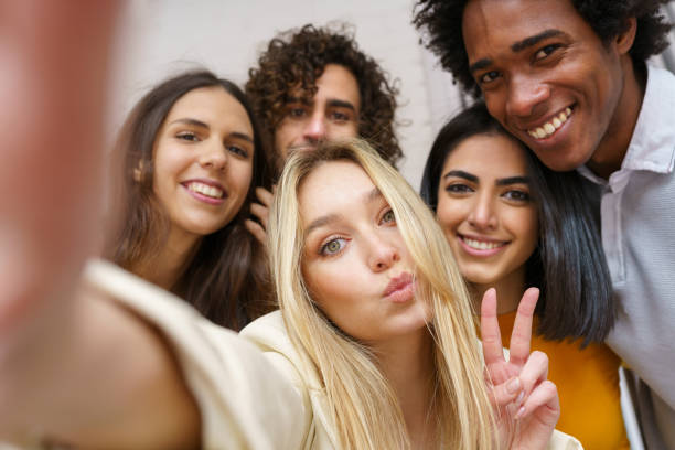 istock Multi-ethnic group of friends taking a selfie together while having fun outdoors. 1397548143
