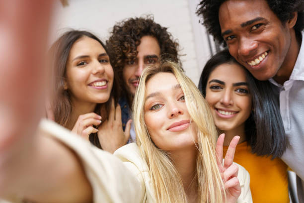 istock Multi-ethnic group of friends taking a selfie together while having fun outdoors. 1397548145