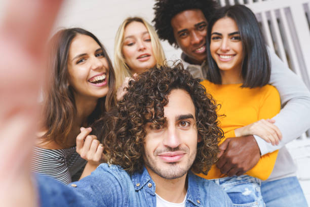 istock Multi-ethnic group of friends taking a selfie together while having fun outdoors. 1397548164