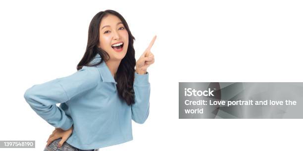 Beautiful Young Asian Woman Pointing Up To Copy Space And Looking At Camera With Smile Face And Happy Pretty Girl Act Like A Satisfied Product Use For Advertising With Isolated On White Background Stock Photo - Download Image Now