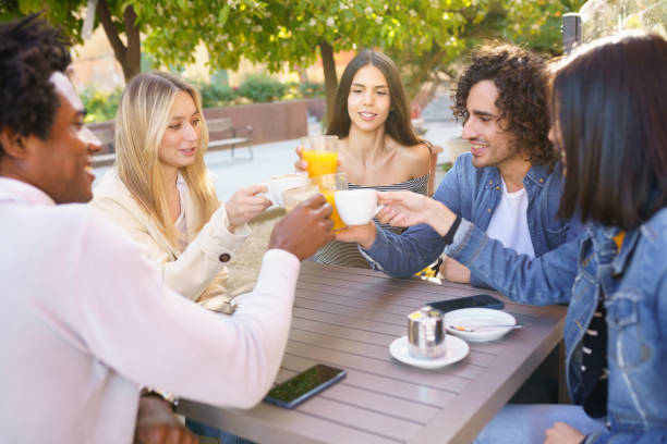 istock Multi-ethnic group of friends toasting with their drinks while having a drink together. 1397548420