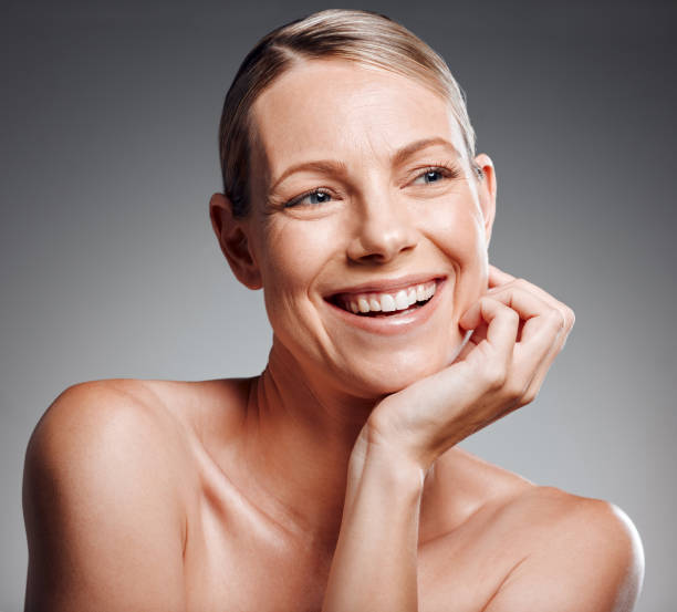 istock Beautiful mature woman posing in studio against a grey background 1397549079