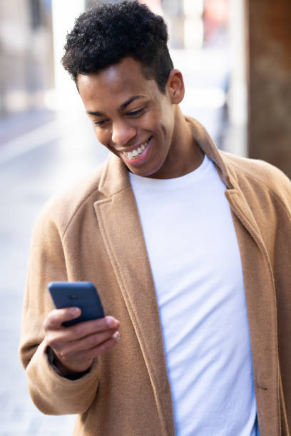 istock Young black man using his smartphone outdoors. 1397549237