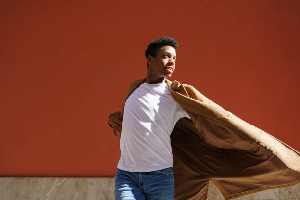 istock Young black man dancing on red urban wall. 1397549346