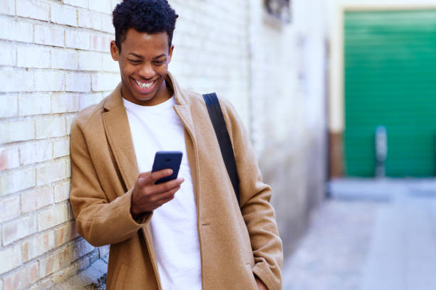 istock Young black man using his smartphone outdoors. 1397549391