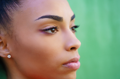 Close-up portrait of beautiful young black girl outdoors