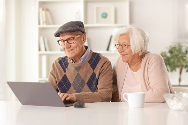 istock Happy elderly man and woman using a laptop computer 1397549767