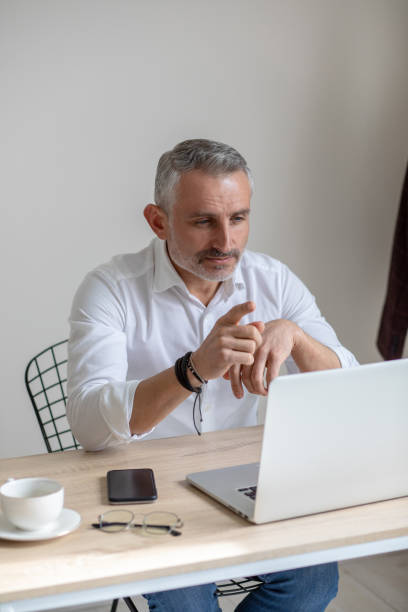 istock Man looking at laptop pointing finger at screen 1397549833