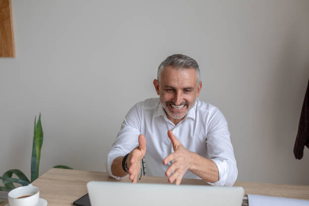 istock Cheerful persuasive man talking on video call on laptop 1397549846