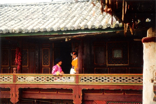Lugu Lake and yongning Township,in northern Yunnan province, China.There lived the Mosuo tribe with traces of maternal clan.Sisters were chatting at home.Film photo in 08/29/1999,Lugu Lake,Yunnan