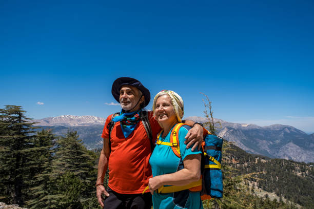istock Senior couple with backpack trekking mountain view have positive expression,enjoy spending time together 1397553001