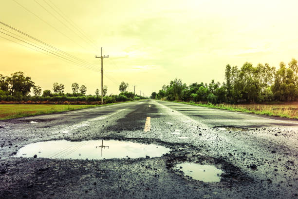istock puddles on the road when it rains. 1397553684