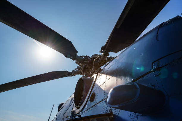 istock Looking up military helicopter blades, bright sun and sky background 1397554183