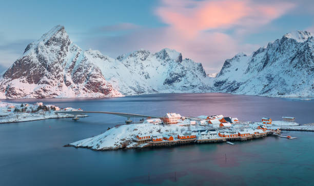 view from above to Sakrisøya Island with mountains on background at sunrise - Lofoten Islands, Norway. Europe view from above to Sakrisøya Island with mountains on background at sunrise - Lofoten Islands, Norway. Europe reine lofoten stock pictures, royalty-free photos & images