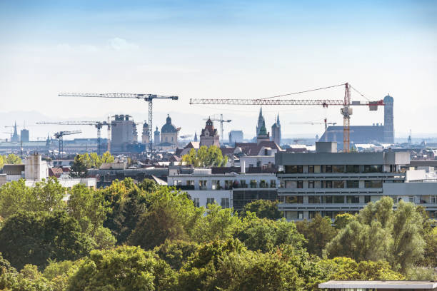panoramic view over Munich cityscape with Frauenkirche and cranes at hazy day