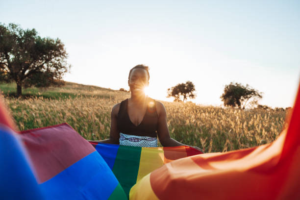 istock LGBTQ+ pride, woman holding a rainbow flag 1397556018