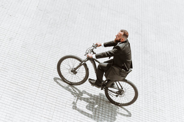 istock Fun Times For Bearded Businessman Enjoying Riding Bicycle To Work 1397556302