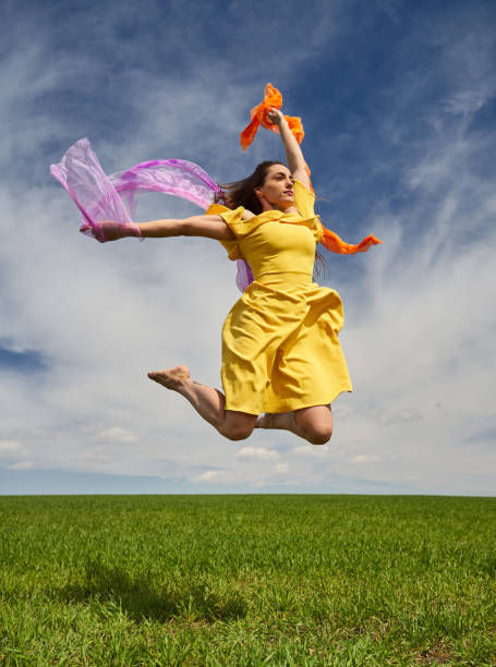 istock Young woman jumping for joy on a wheat field 1397556905
