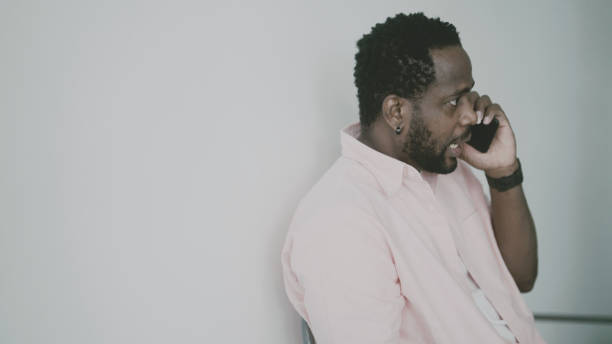 istock Irritated black man talking on the phone 1397557074