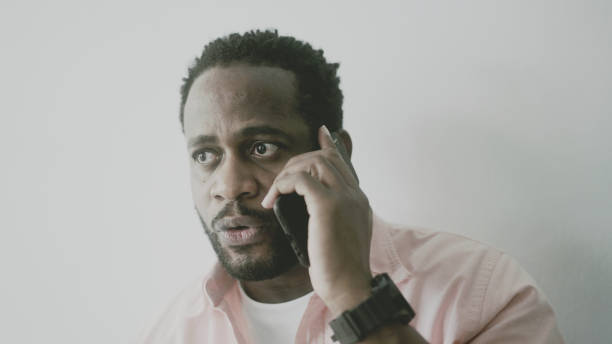 istock Irritated black man talking on the phone 1397557088