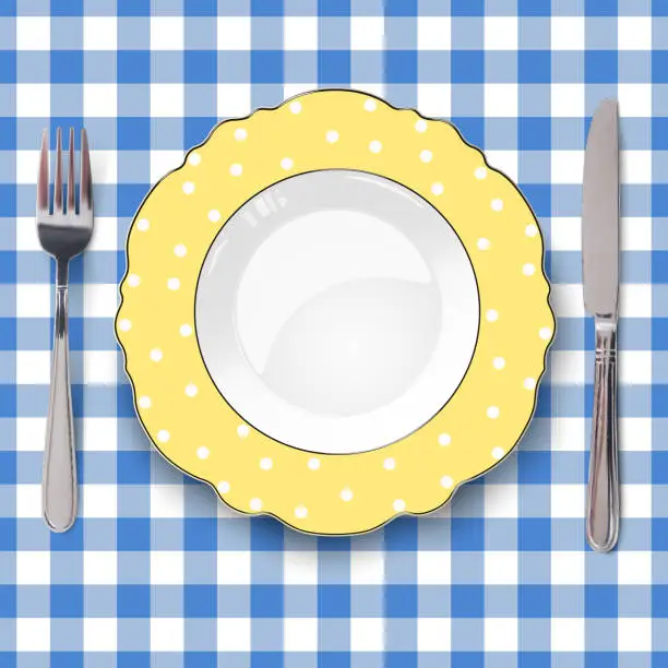 Vector illustration of Empty vector yellow color dish with figured edges and white polka dot pattern and knife and fork placed on classic check blue tablecloth. Close up view from above.