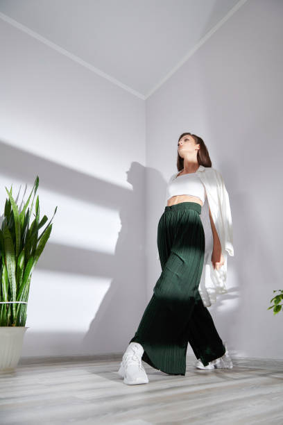 istock model in modern stylish clothes posing for a photographer on a white wall 1397560962