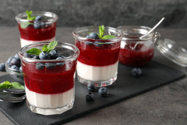 istock Delicious panna cotta with fruit coulis and fresh blueberries served on grey table. Space for text 1397565597
