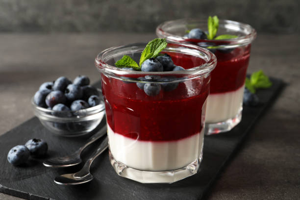 istock Delicious panna cotta with fruit coulis and fresh blueberries served on grey table 1397565598