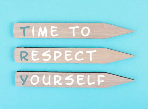 Photo of The words time to respect yourself are standing on wooden arrows, responsibility and development, motivation concept