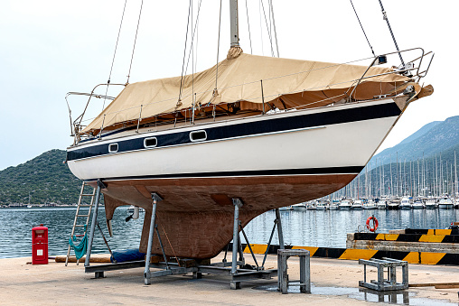 A boat in dry dock for cleaning or repair in Kaş Marine. Seasonal Mending.