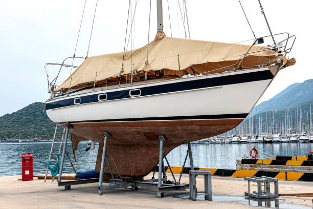 Maintenance sailing boat on dry dock A boat in dry dock for cleaning or repair in Kaş Marine. Seasonal Mending. dry dock stock pictures, royalty-free photos & images