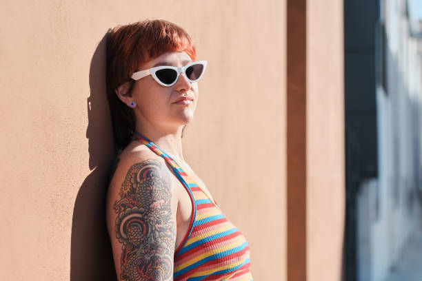 istock medium shoot of a non-binary young with sunglasses resting against a brown wall 1397568686