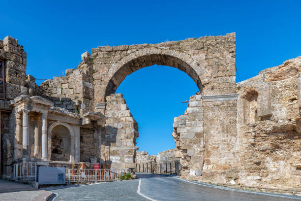 Ancient gate in Side, Turkey Ruins of the ancient main gate in Side, Turkey temple of apollo antalya province stock pictures, royalty-free photos & images