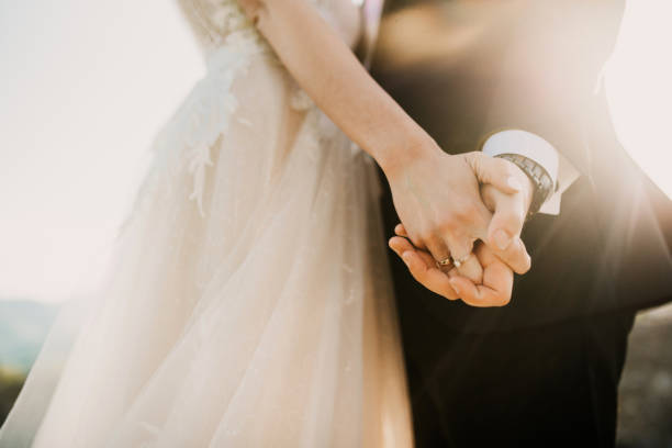Together we make the world better! Bride and groom's hands wedding fashion stock pictures, royalty-free photos & images