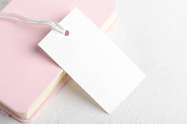 istock Blank paper rectangular price tag mockup isolated on bink and white background, close up 1397578796