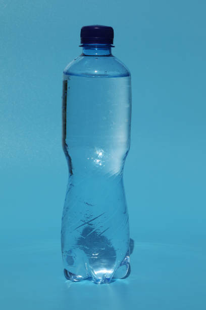 istock Bottle of cold water on blue background 1397583721