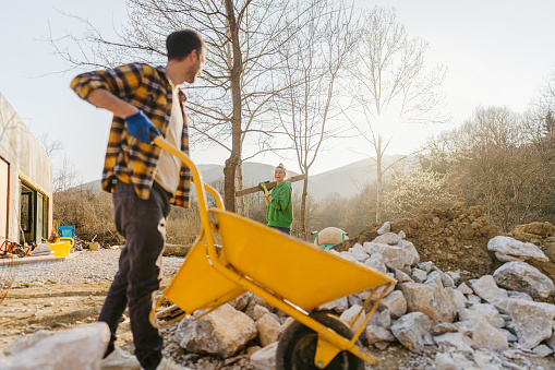 Photo of a young couple working on their yard makeover project.