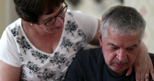 istock Preoccupied senior man seeking help and support. Wife consoling older husband 1397585004