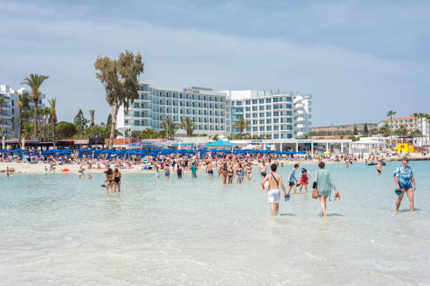 Agia Napa, Cyprus - April 07, 2018: Tourists walking and bathing on Nissi beach
