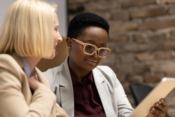 istock Two young businesswomen talking about work 1397588290