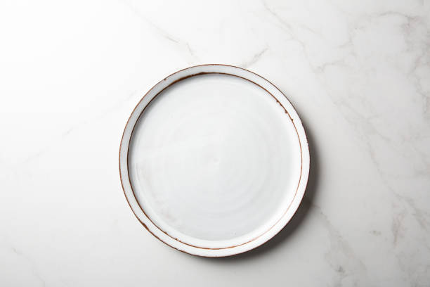 istock Overhead view of empty plte on light surface food concept 1397588559
